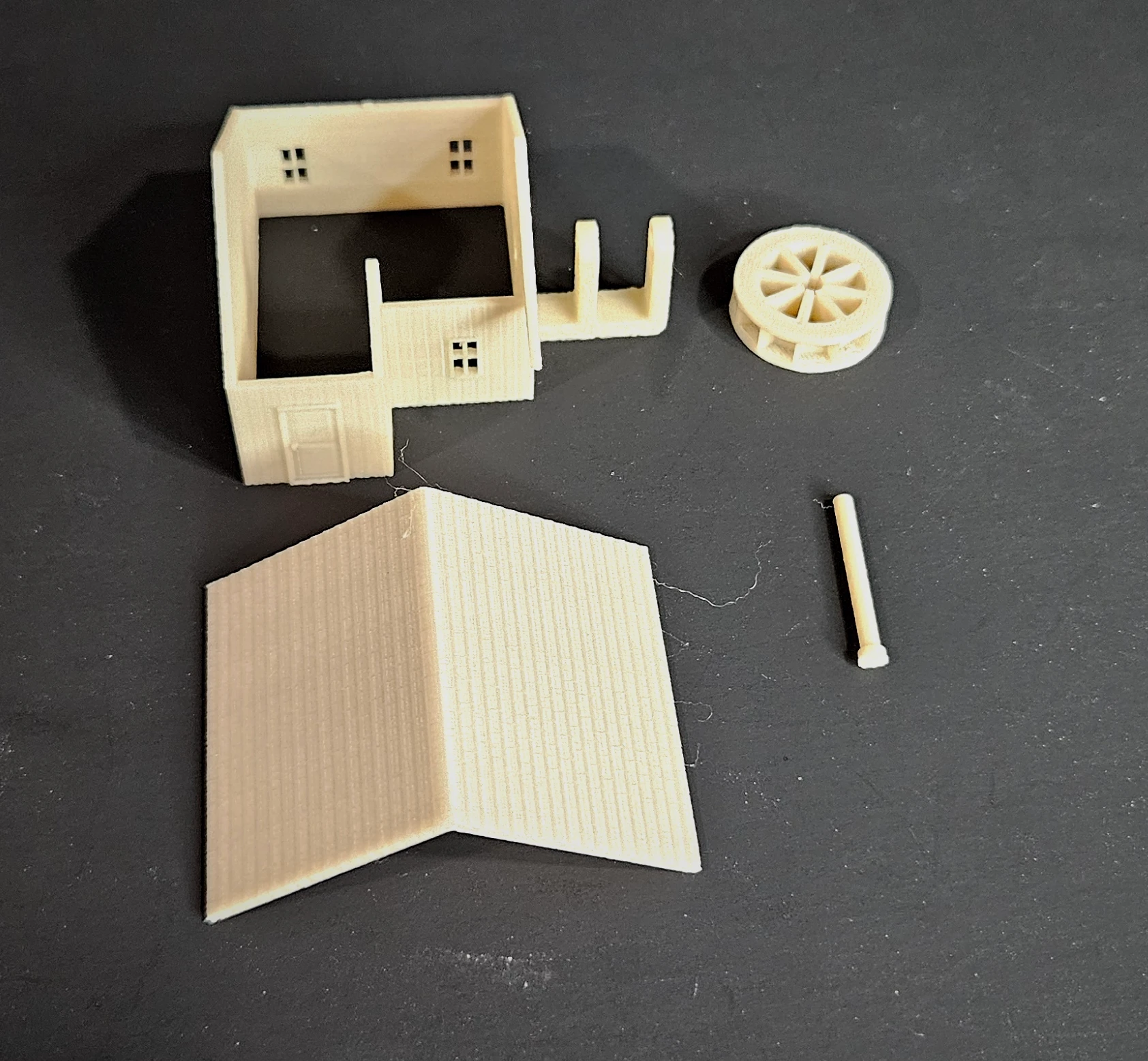 N scale waterwheel with large building on display